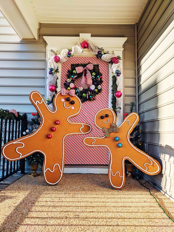 giant gingerbread men with colorful touches make the porch bright and fun and can be DIYed for outdoor Christmas decor