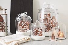 large glass jars and cloches, with gingerbread houses, mini trees with lights are adorable alternative Christmas terrariums