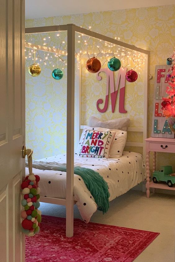 lights and oversized ornaments attached to the frame, pretty Christmas bedding and a fun marquee light sign for a holiday feel