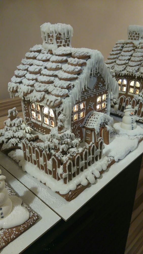 lit up glazed gingerbread houses with Christmas trees and porches are amazing for styling your space for the holidays
