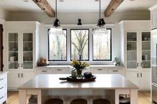 a clean white kitchen with rough wooden beams that add warmth and coziness to the space and make it catchy