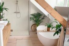 a minimalist bathroom with a wooden beam, a large window, a tub and a shower space and a floating wooden vanity