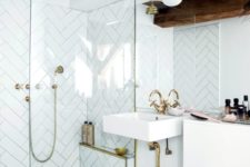 a neutral modern bathroom with white tiles, dark stained beams and gold fixtures plus white appliances
