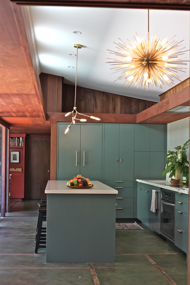 a forest green mid-century modern kitchen with white countertops, a sunburst chandelier and a tile floor  (cocoon home design)