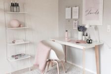 a feminine home office with touches of blush and wall-mounted shelving unit that is delicate and airy