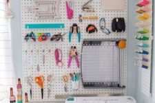 a pegboard with hooks and shelves to hold everything you need and a pegboard with colorful yarn