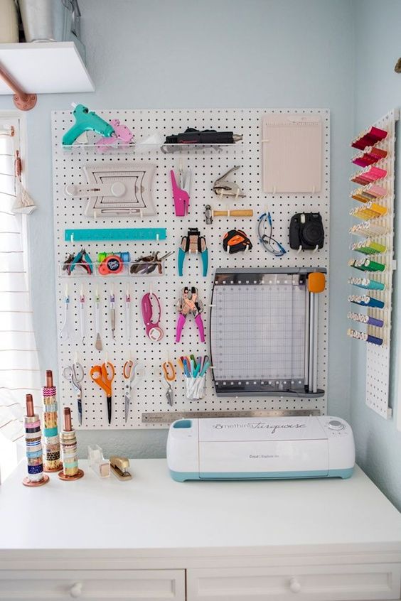 a pegboard with hooks and shelves to hold everything you need and a pegboard with colorful yarn