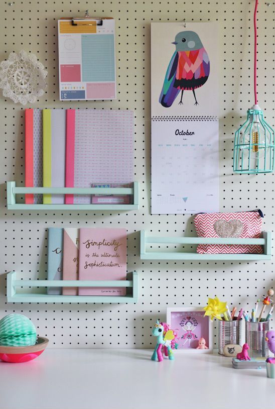 a pegboard with mint mini shelves is a cool idea to style a home office or a kids' space
