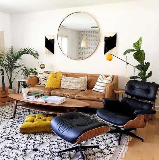 a stylish mid-century modern living room with a leather sofa, a lovely oval coffee table, a black lounger