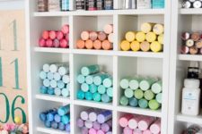 an open storage unit with shelves is great for storing paints or markers