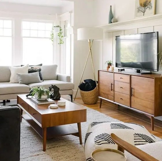 stained mid-century modern furniture - a TV unit and a coffee table- add chic and coziness to this living room
