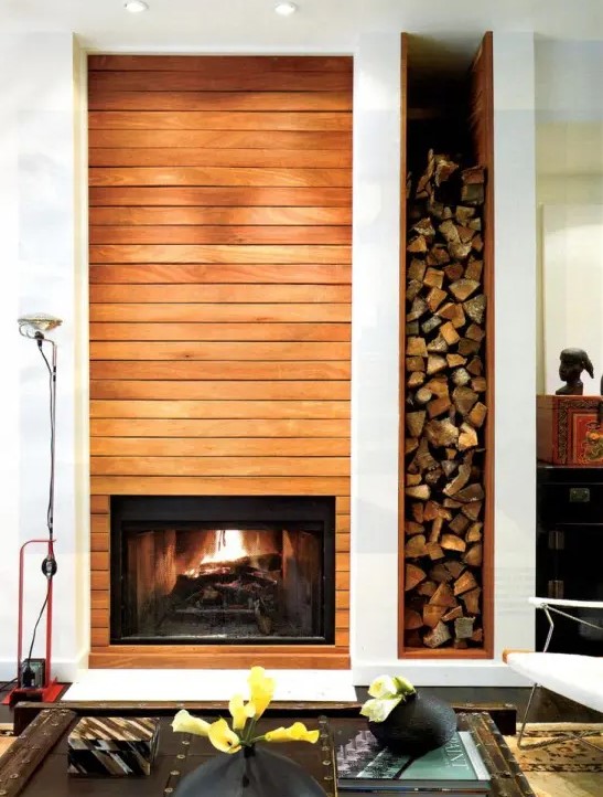 a built-in fireplace and a niche for firewood next to it add warmth and coziness to the space