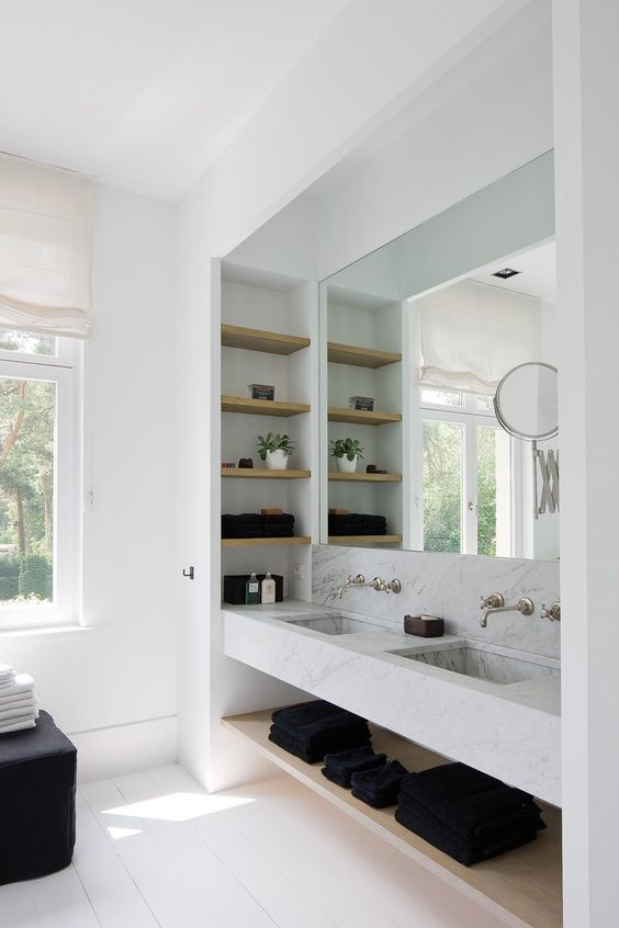 a contemporary bathroom with a large niche, with a double sink and niche shelves inside is a cool idea