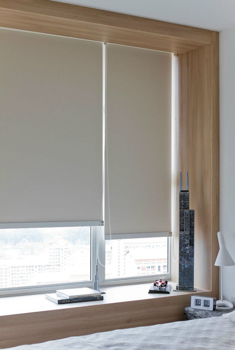 a contemporary bedroom and windows finished with neutral sleek shades that highlight the style and continue the color scheme