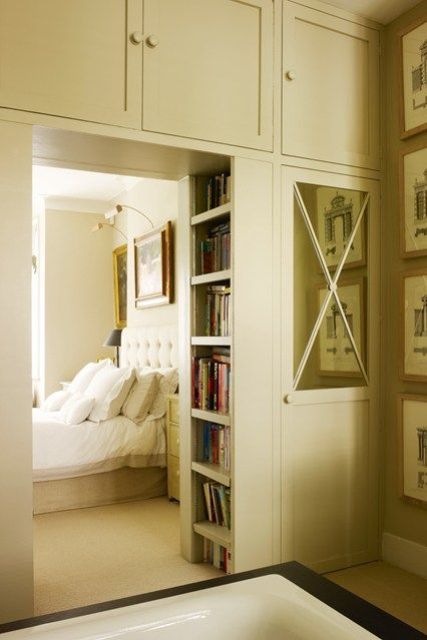 a cool doorway with closed storage cabinets over it and built-in bookshelves right inside the doorway is a very creative idea to declutter the space