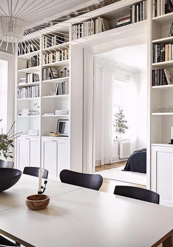 a doorway with open shelves and cabinets surrounding it is a cool idea to store a lot of things without buying separate storage units here and there