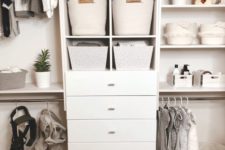 a large closet with a dresser, fabric baskets, planters and clothes hangers looks neat and chic