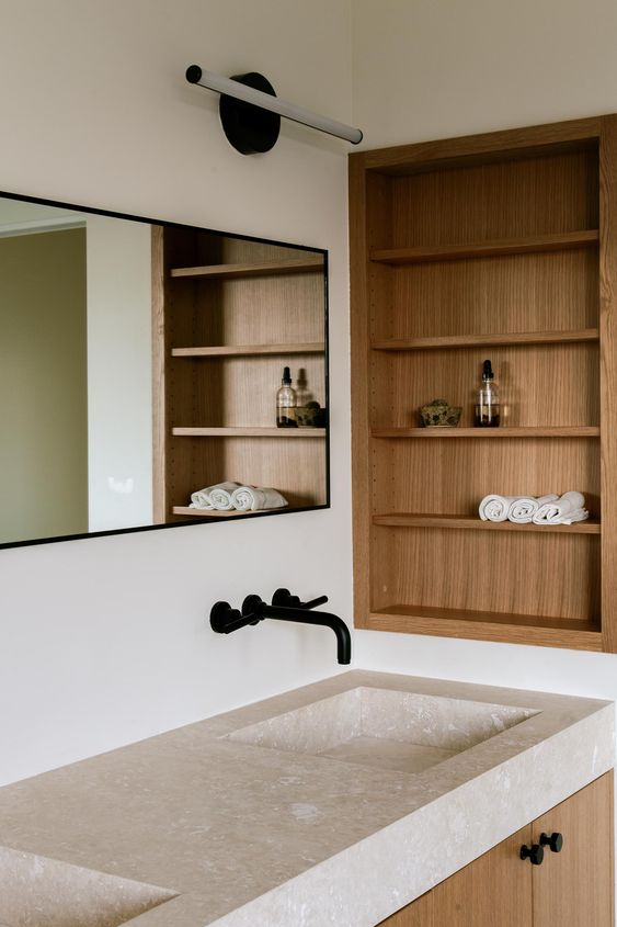 a minimalist bathroom with niche and shelves done with wood completely is a stylish space that adds warmth here