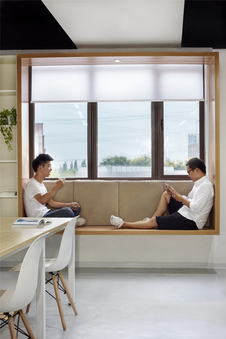 a minimalist space and semi sheer window shades that keep the space private enough yet let light inside