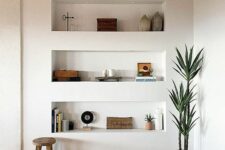 a modern space with a wooden ceiling with beams, a parquet floor and three niche shelves for storing stuff