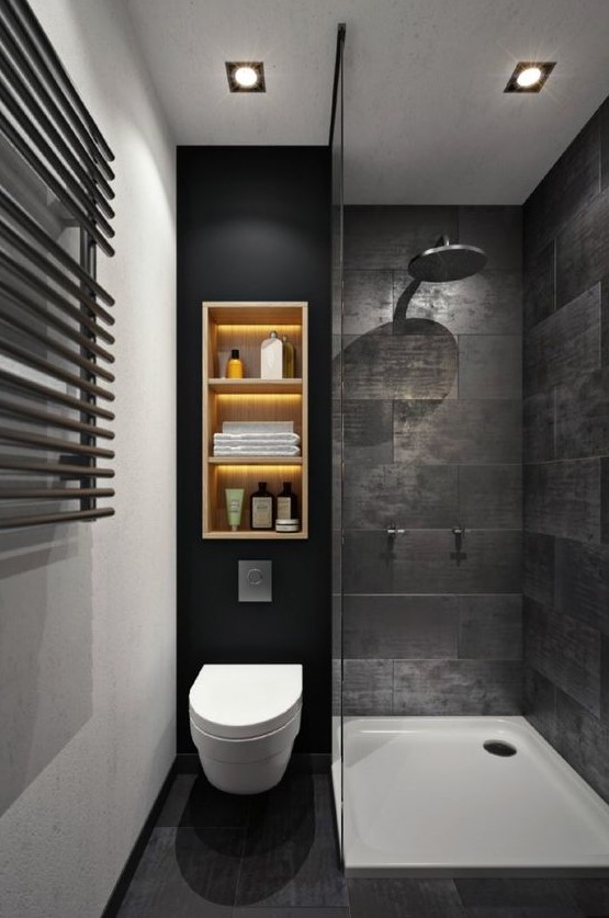 an almost pure black bathroom with stone wall tiles