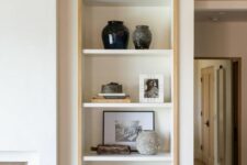 a niche with shelves lined up with stained wood is a stylish idea for a living room, here you can display anything you want