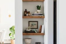 a niche with wooden shelves and additional light is a perfect way to style your awkward nook the best way possible
