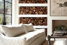a non-working fireplace and an open storage unit with firewood make this Provence room cozy and welcoming