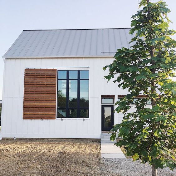a practical modern wooden plank shutter like this one will hint on the origins of the house and keep it private