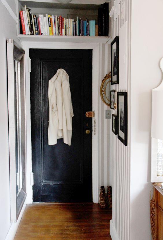 a small bookshelf over the entrance is a cool idea to store some books without wasting your floor space at the same time