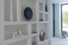 a whole wall taken by various niches that are used to display decor and add decorative value to the space