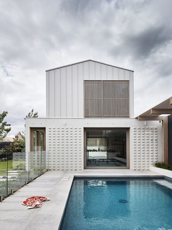 a wooden slab screen covering the upper window to make this level of the house more private and relaxed