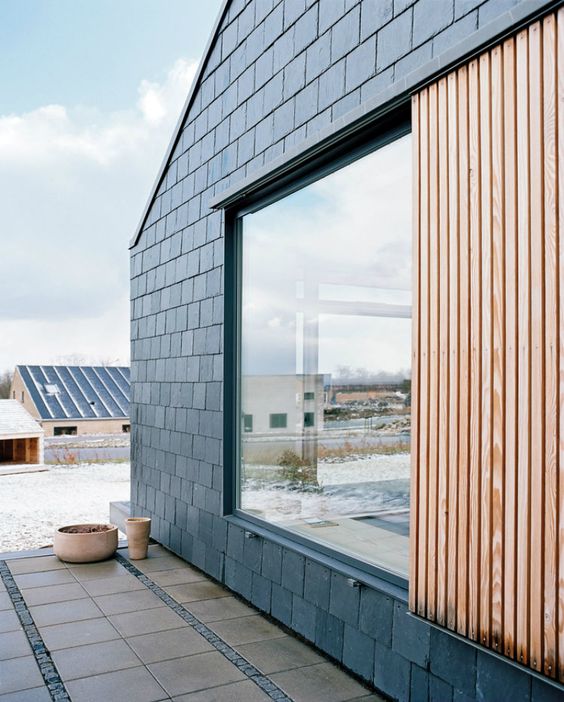 modern light-stained exterior wooden shutters to keep the house private and to defend it from harsh weather conditions