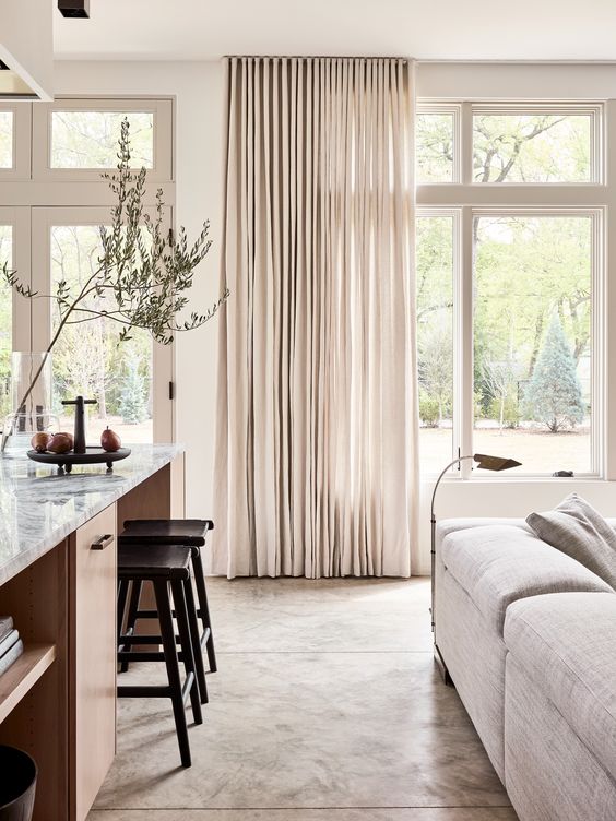 neutral drapes always add an airy feel to the room making it more welcoming and visually larger