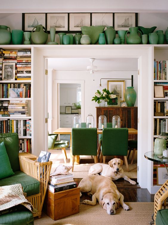 open shelves around the doorway and a long shelf over it are used to display vases and books is a cool idea to incorporate a touch of color and store things