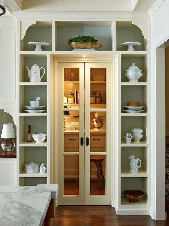 open shelves surrounding the doorway display pretty tableware and teaware and show off some potted plants are a super cool idea