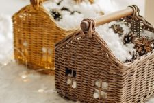 pretty house-inspired baskets with faux snow and pinecones plus lights are a great idea for a rustic space at Christmas