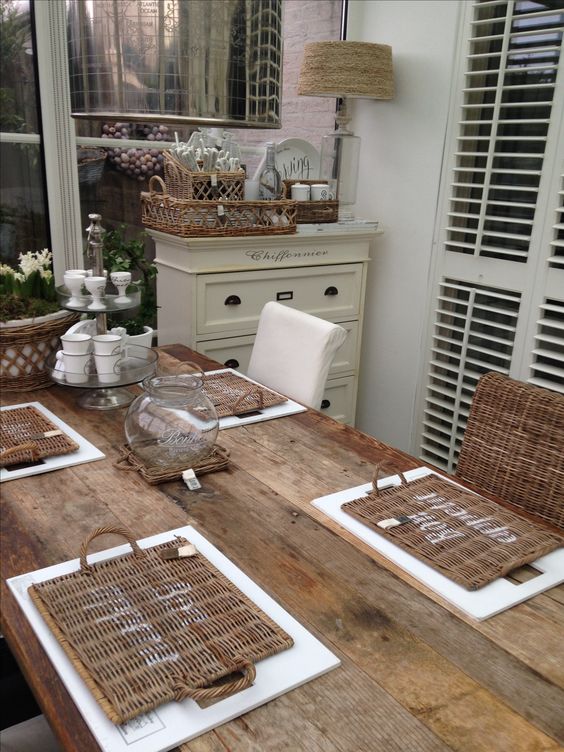 wicker chairs, wicker placemats, a wicker table lamp and soem wicker baskets for storage fit a rustic space perfectly