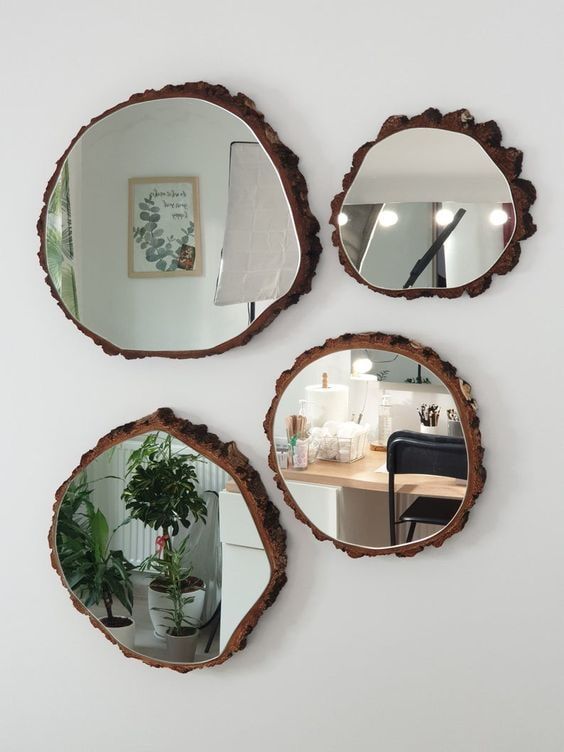 a beautiful and creative arrangement of wood slices with mirrors will be a nice rustic addition to the space, perfect for a rustic or organic room