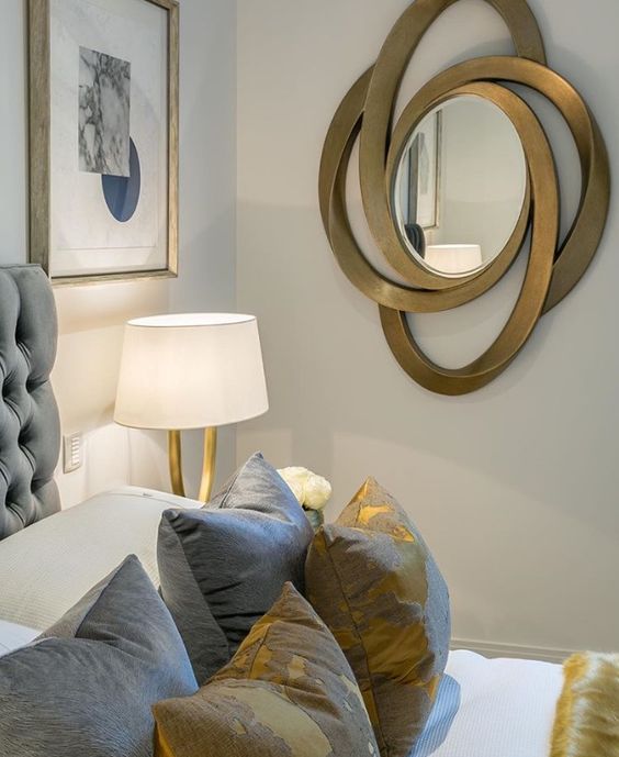 a bold and catchy oval mirror in a unique and catchily shaped frame that looks somewhat sci-fi and bold