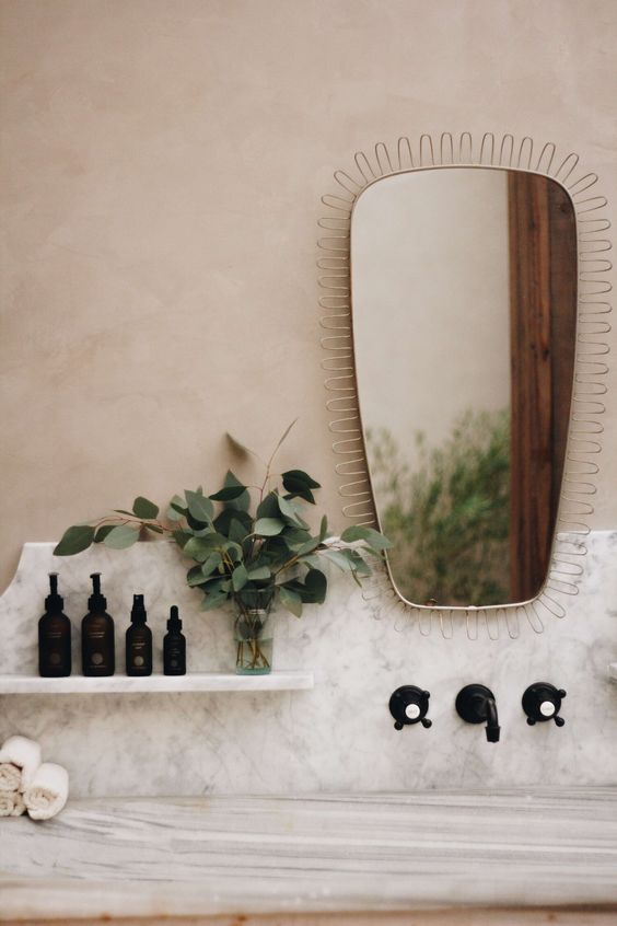 a catchily and soft-shaped mirror with a wire frame will be a nice idea for a mid-century modern space