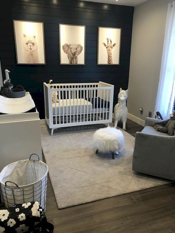 a chic nursery with a black plank wall and soem white and grey furniture to refresh the room