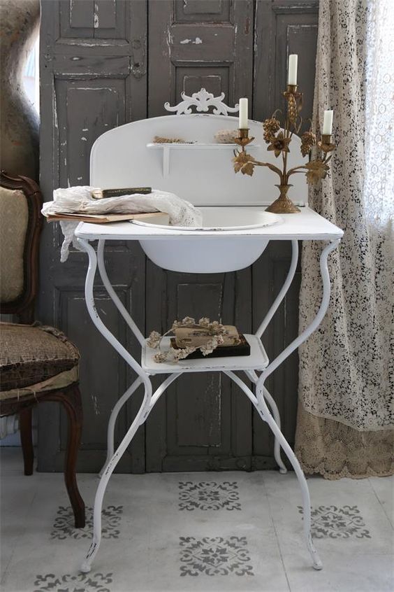 a creative and chic metal sink stand with a tiny shelf is a lovely idea for a vintage, shabby chic or rustic space, it looks very nice