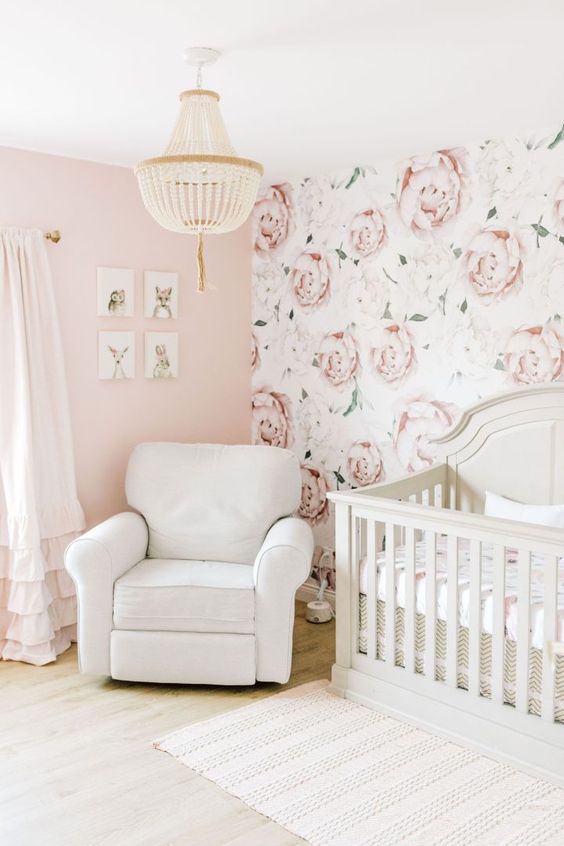 a farmhouse girl bedroom with a pink and a floral wall, neutral furniture, a beaded chandelier and a mini gallery wall