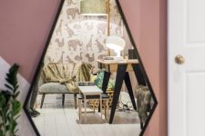 a geometric drop shaped mirror with a black frame is a stylish and catchy solution for a modern space, it will bring a unique geo shape to the space