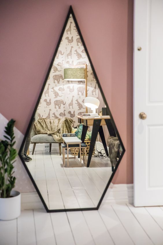 a geometric drop shaped mirror with a black frame is a stylish and catchy solution for a modern space, it will bring a unique geo shape to the space