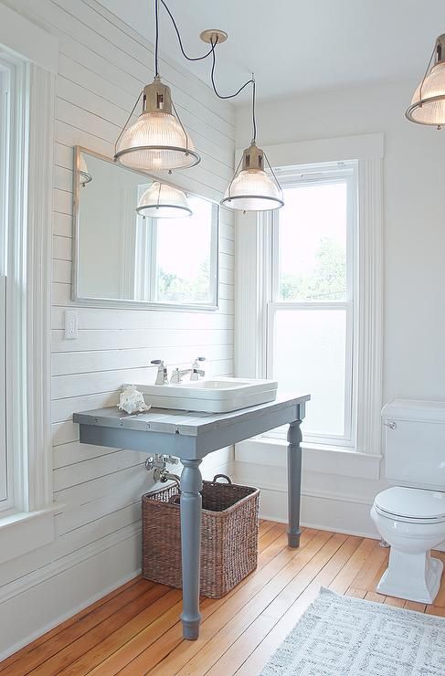 a grey blue wall-mounted two-legged sink stand is a cool idea for a rustic, farmhouse or vintage rustic bathroom