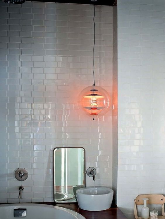 a large pendant lamp of clear glass and metallic touches will accent any bathroom makign it more eye-catchy