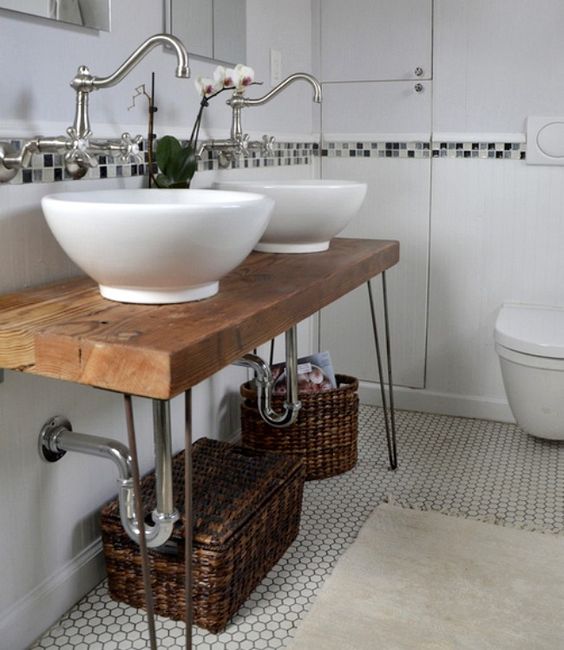 a lovely rustic bathroom vanity made of a hairpin leg table, with baskets for storage is a perfect idea for a rustic or farmhouse space