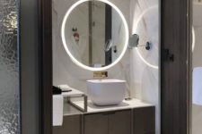 a minimalist bathroom with built-in lights in the mirror and wall around the vanity looks super chic and amazing